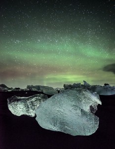 The aurora lights up the sky over standed icebergs near Jokulsarlon